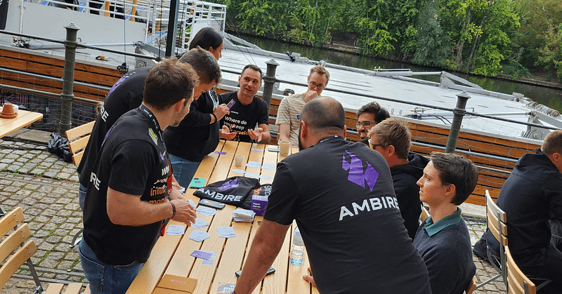 People on a table playing the Paper Hands card game