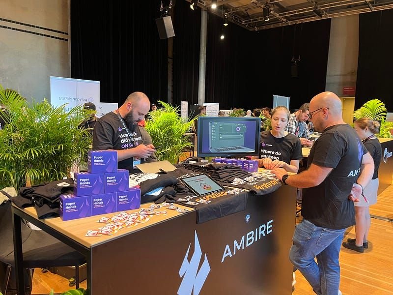 Ambire's team standing around a table at an event