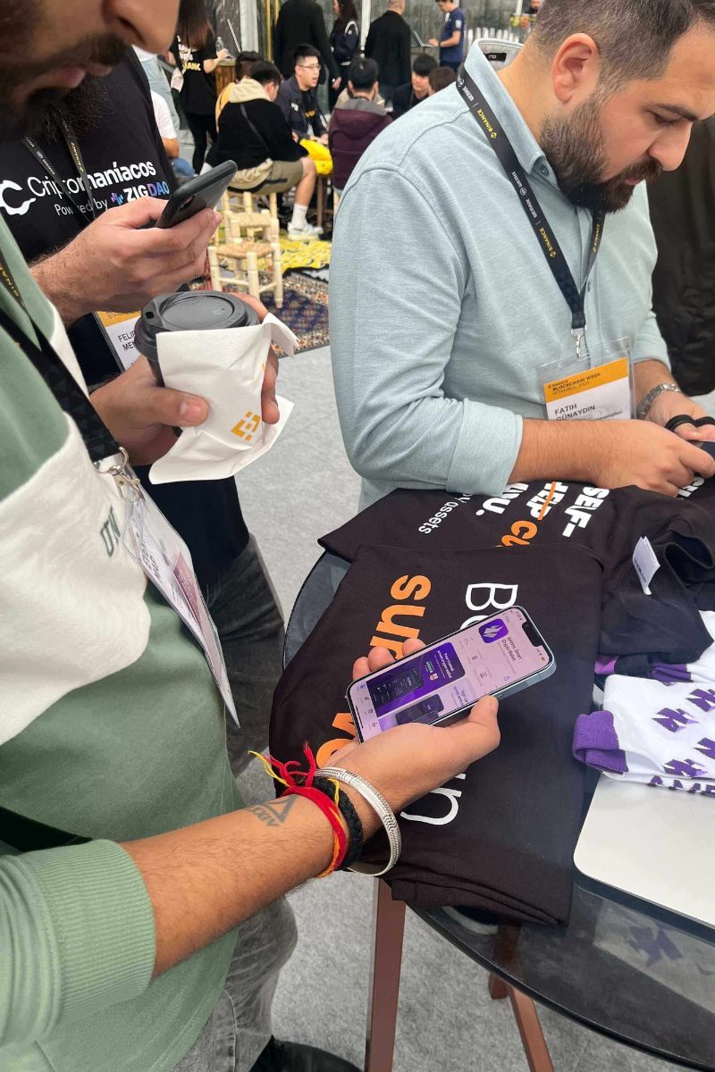 Event visitors installing Ambire Wallet on their mobile devices